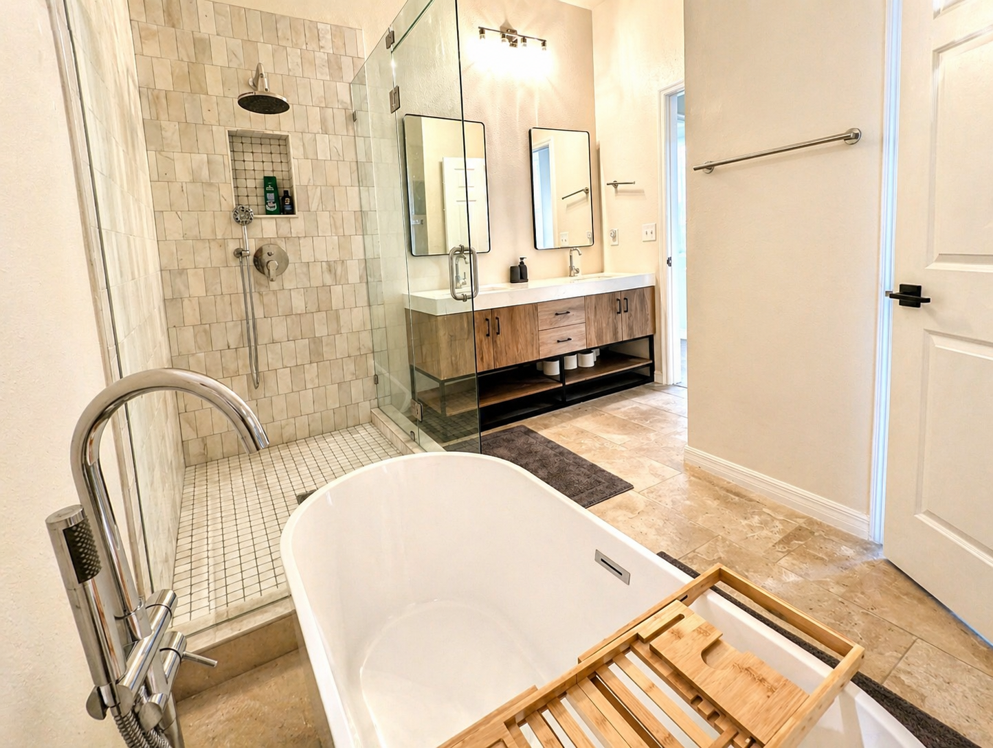 Relax and unwind in this spa-inspired bathroom featuring a deep soaking tub, elegant chandelier lighting, and calming modern décor designed for a luxurious retreat experience.