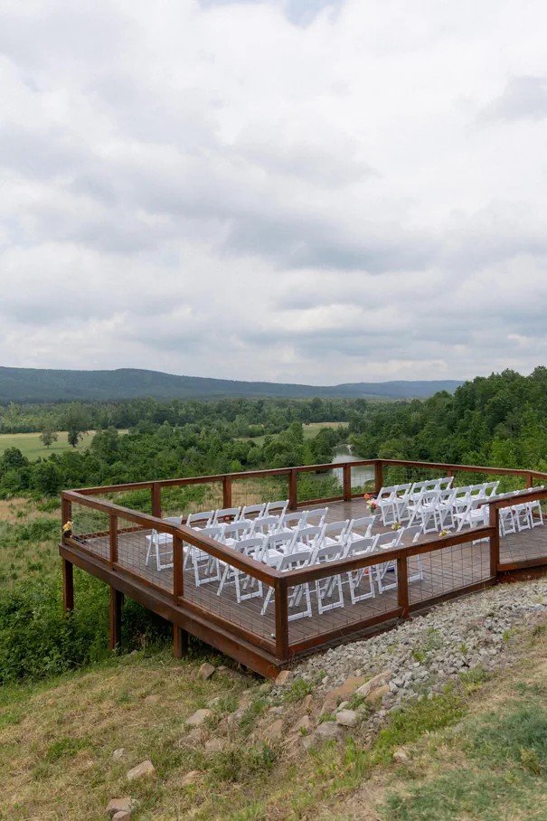 Outdoor ceremony seating with open valley views.