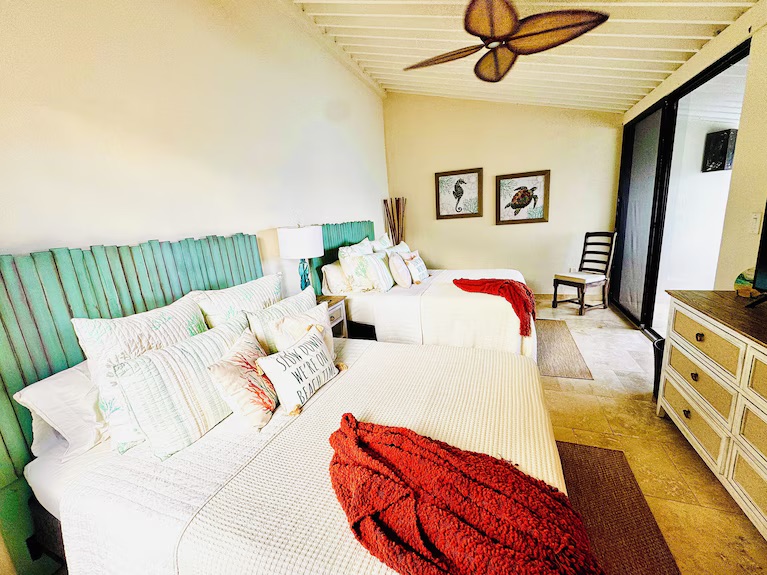 Guest bedroom has two queen beds and another private patio