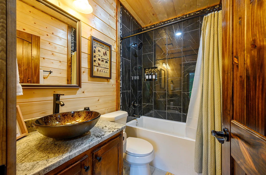 Rustic-modern bathroom with elegant vessel sink and warm wood accents