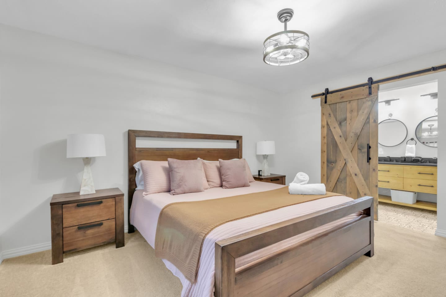 Spacious master bedroom with king bed and blackout curtains