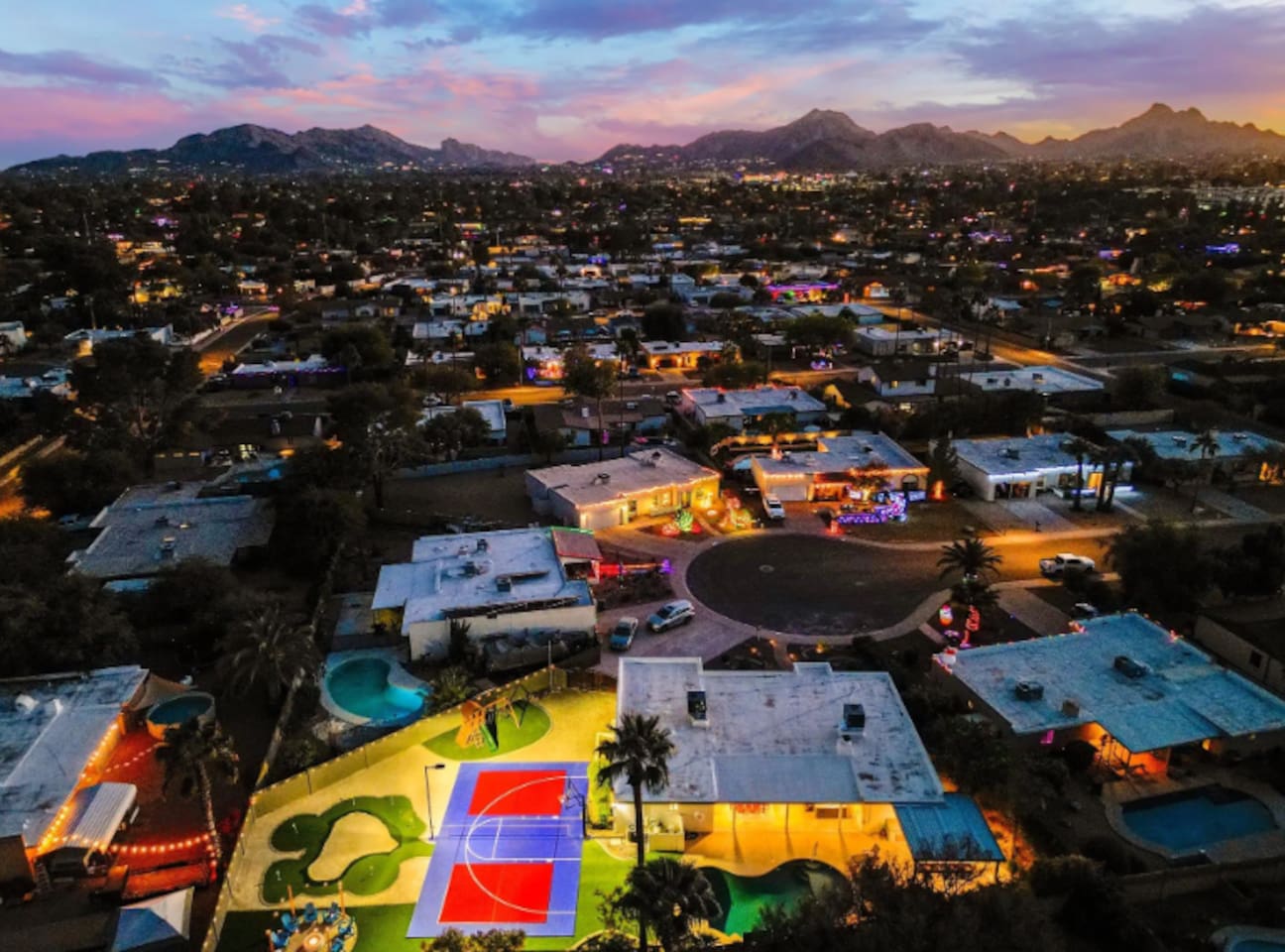 Camelback Mountain on the horizon, string lights below — Scottsdale views most guests only see from a rooftop bar.
