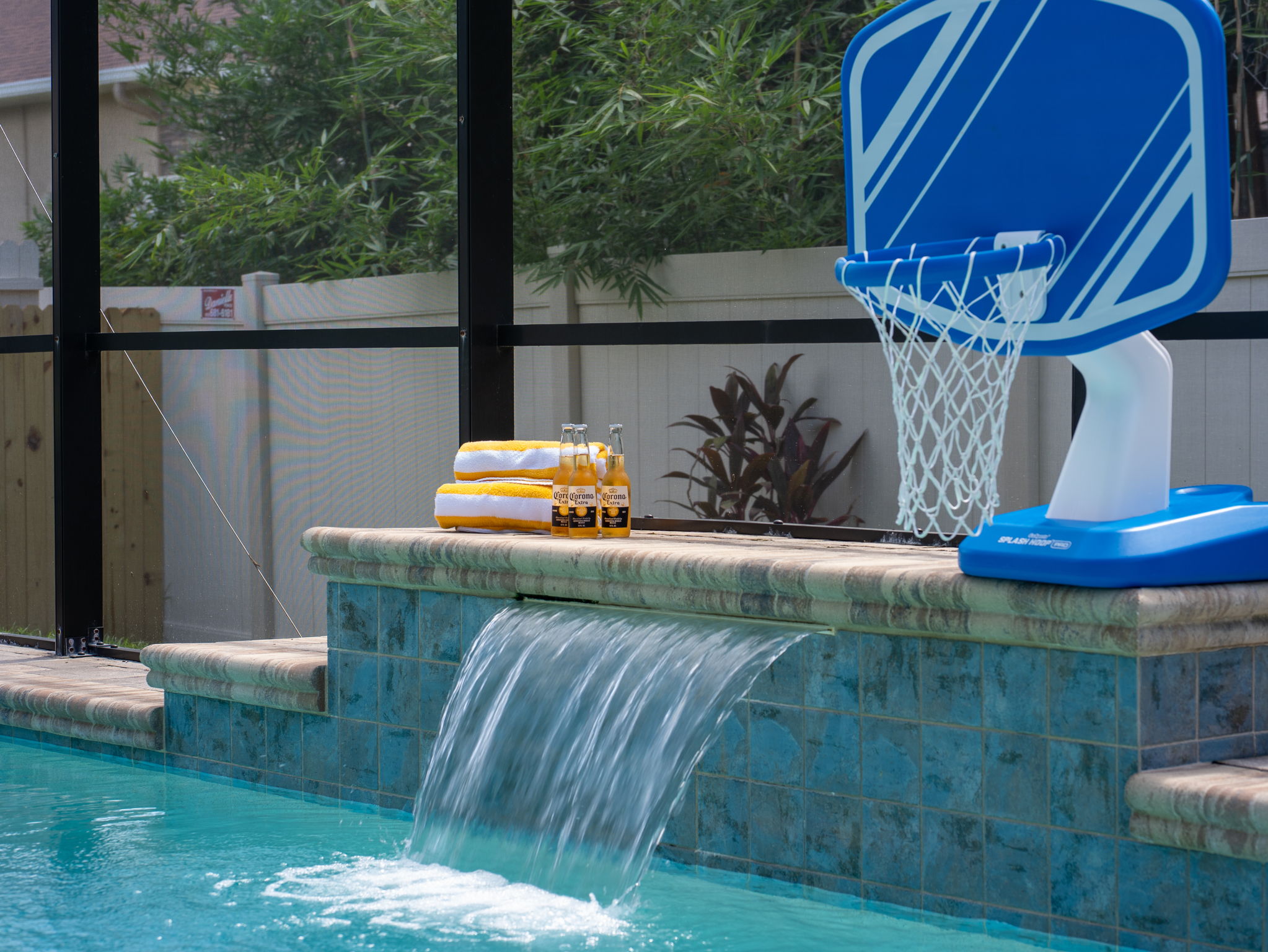 With a crystal-clear pool, waterfall feature, and basketball hoop, this space is perfect for both relaxation and family-friendly fun.