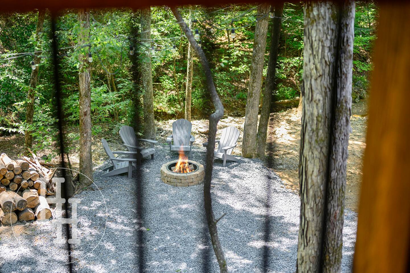 View of the creekside firepit with six chairs. Smore's sticks included.