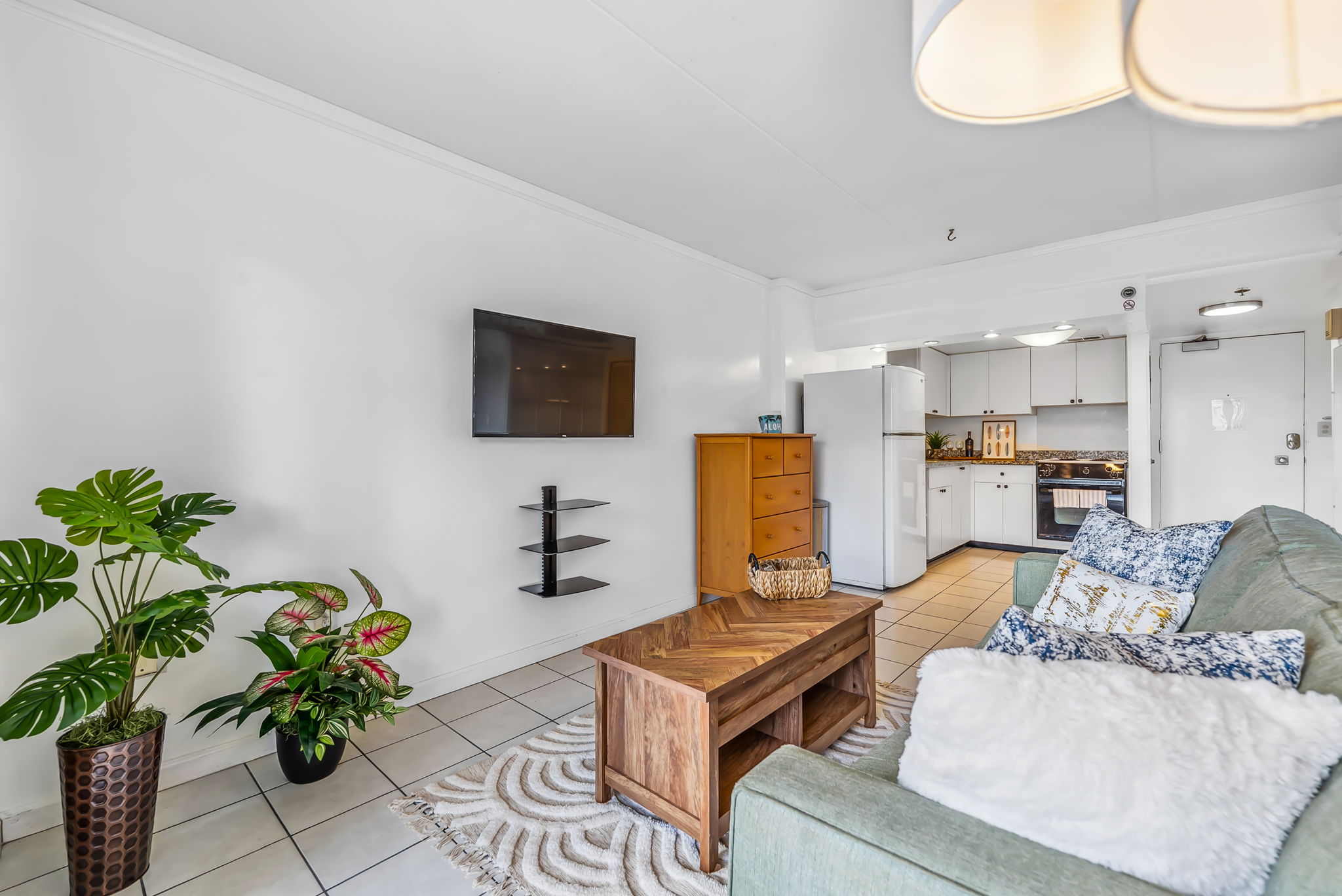 Open floor plan bedroom functions as living space with sofa sleeper and flat screen TV