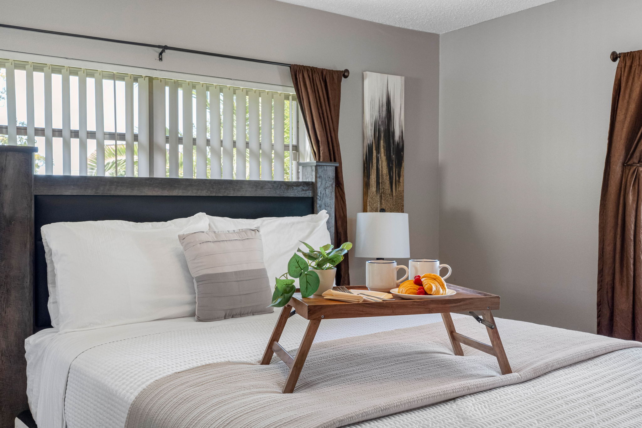 The cozy bed dressed in crisp white linens makes this space perfect for relaxation and restful sleep.