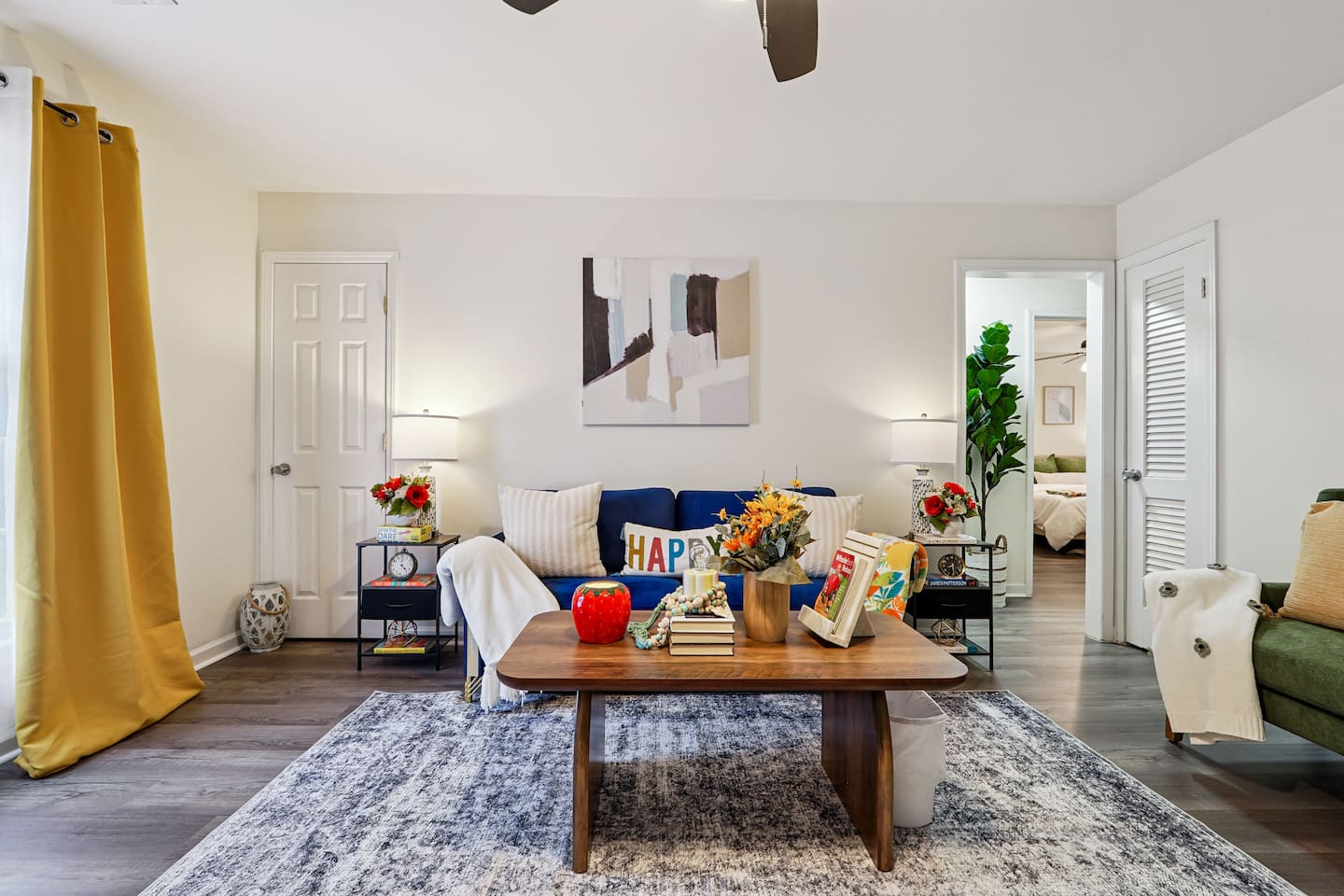The living room features cozy furniture, including a comfortable blue couch, and an Amazon Fire-powered Smart TV for your entertainment. You’ll also find the Xfinity modem conveniently located here, convenient for ethernet connection.