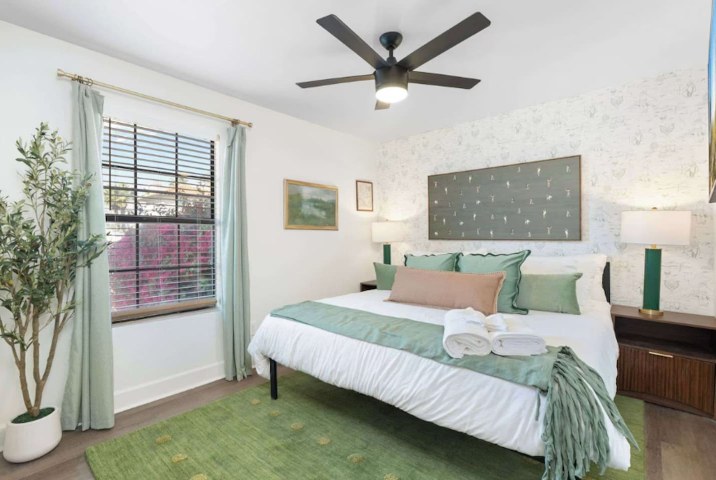 Serene guest bedroom with soft green palette, natural light, and layered textures—a peaceful retreat for rest and relaxation.