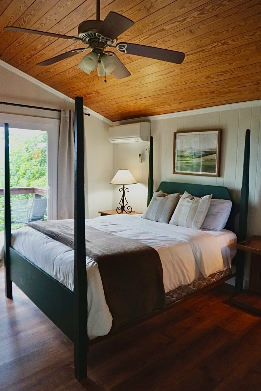 Bedroom Bliss: Relax in style with a plush bed, scenic views, and warm wooden accents!