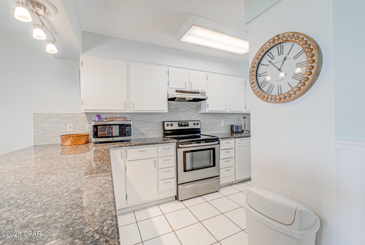 Kitchen includes granite countertops, stainless steel appliances, and plenty of room and storage space.
