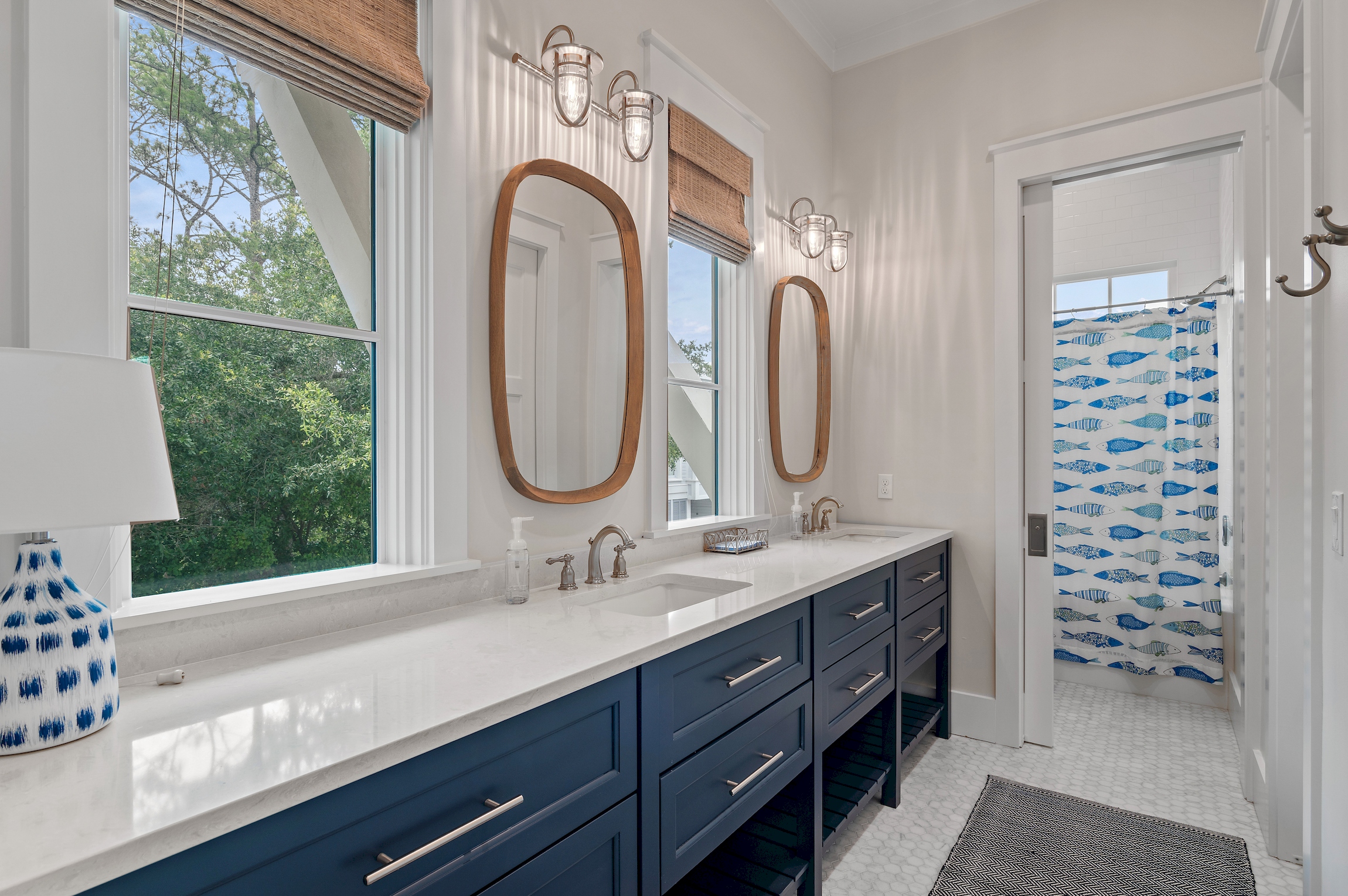 A spacious bunk room bathroom offers a large vanity with two sinks, and a shower/tub combo, perfect for little ones who enjoy a bath.