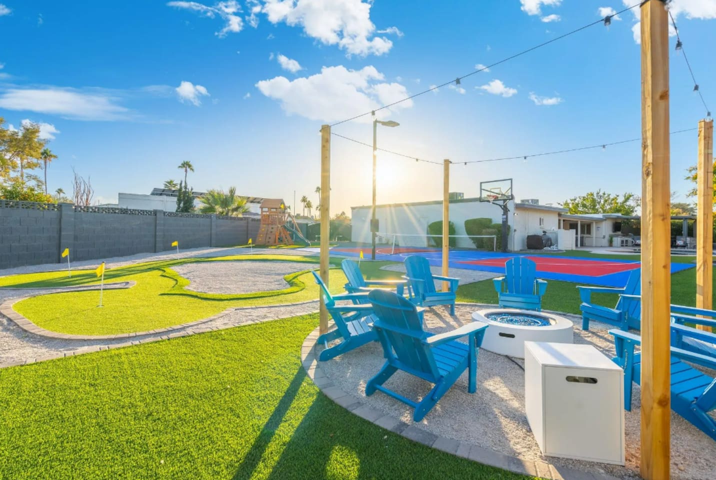 Golden hour hits just right here, with the fire pit and putting green sharing the same corner of the yard.