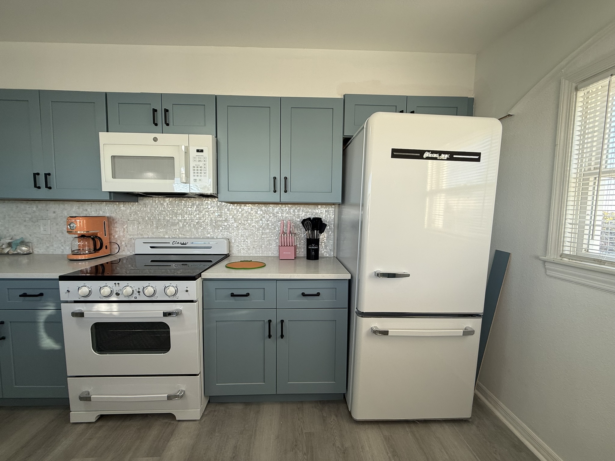 Blue Kitchen Cabinets with Retro Appliances and Mother of Pearl Backsplash!