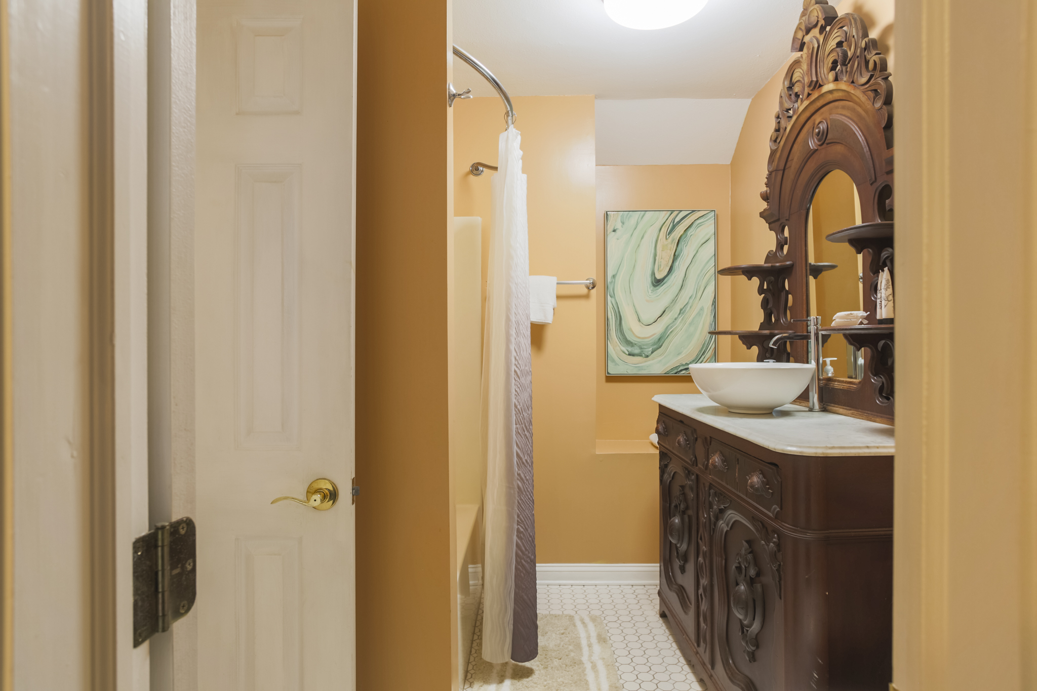 Fresh and functional—the bathroom features a spacious vanity with plenty of room to get ready for the day.