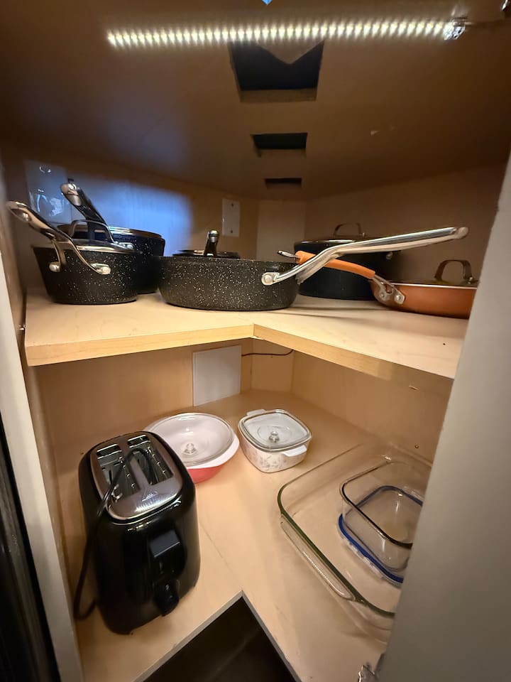 Cookware Storage: Dedicated shelving for the full set of quality pots and pans provides easy access for all your culinary needs.