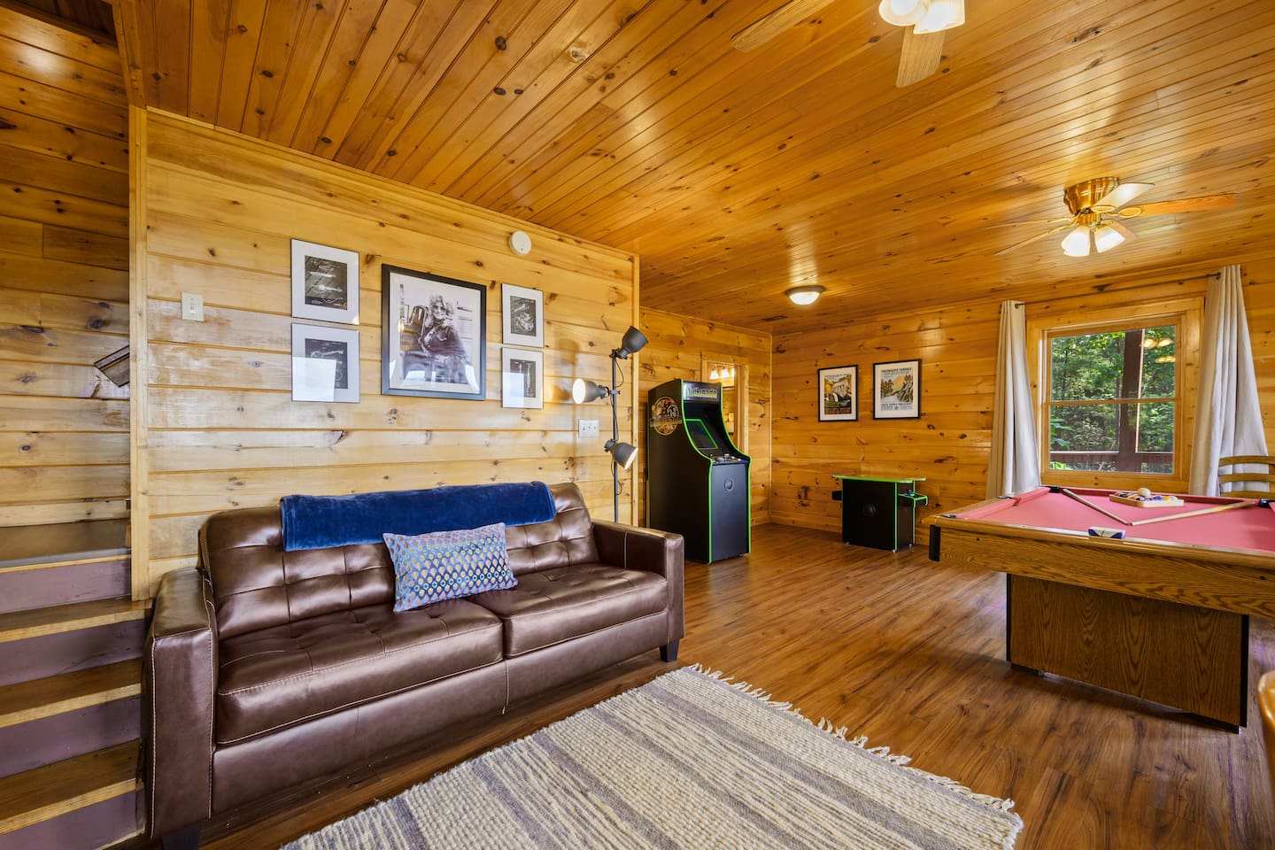 The game room has a comfortable sleeper sofa, pool table, 55" smart TV, 2 multicades, game table, books and games. 