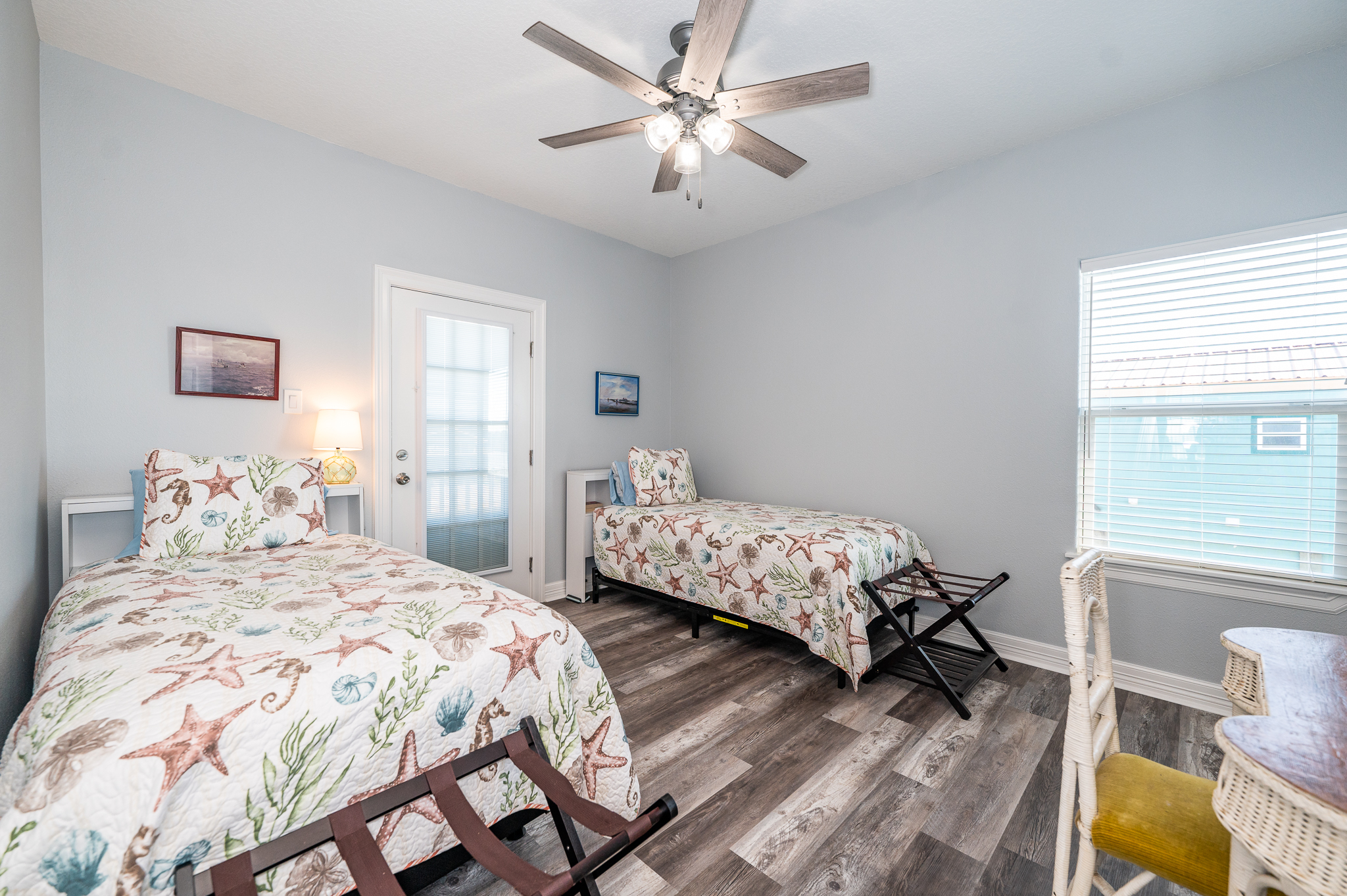 secondary bedroom with 2 twin beds and balcony access