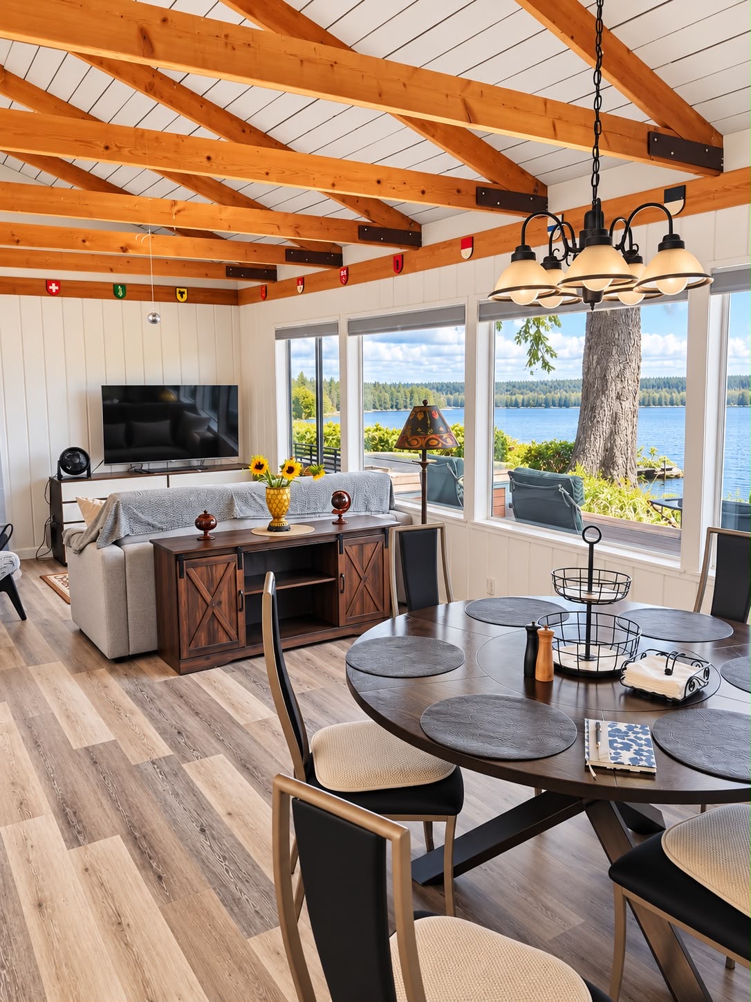 An open, connected living and dining space designed for relaxing and gathering, featuring a king-size pull-out sofa for added sleeping space.