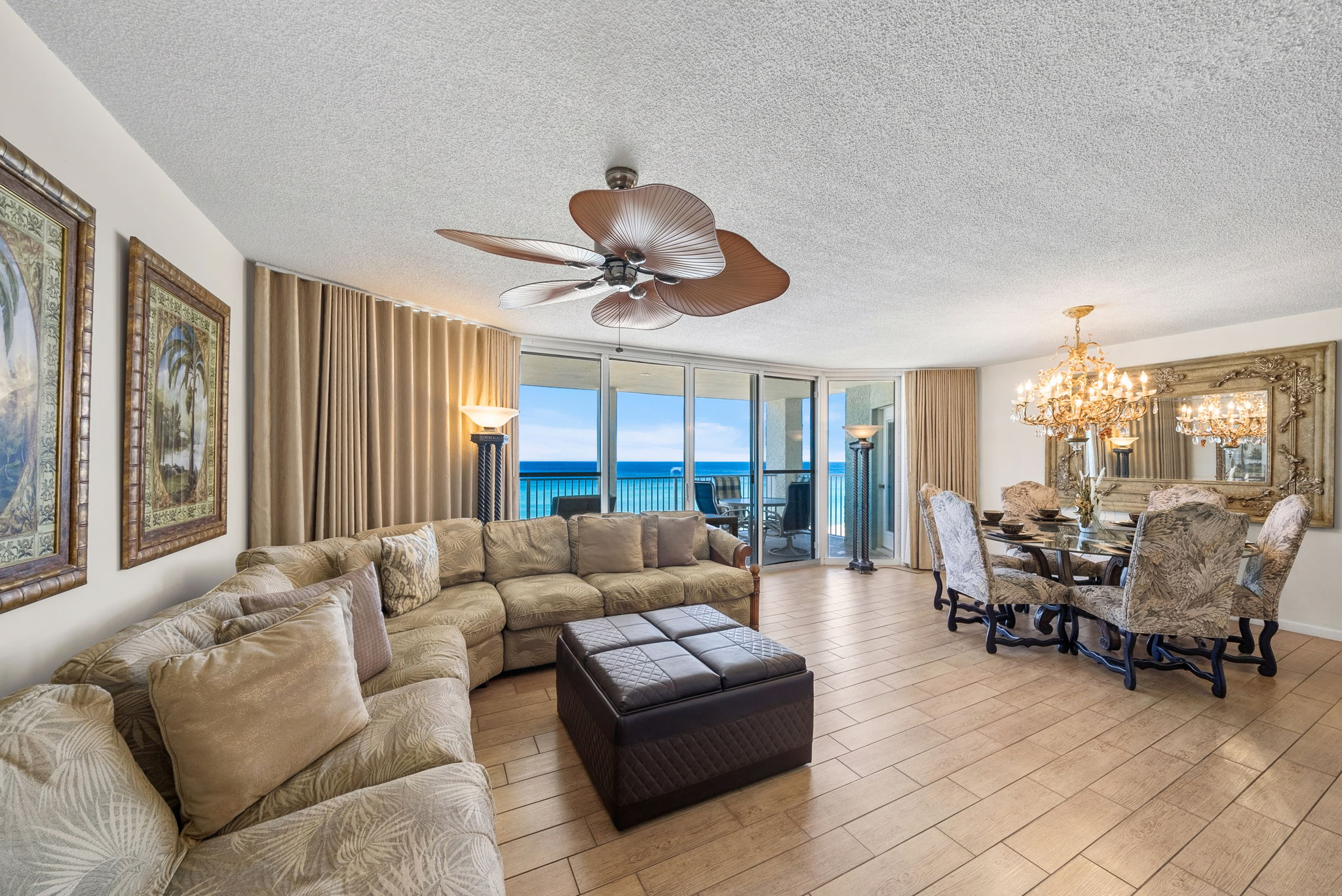 Large living room and dining area with panoramic floor to ceiling windows for breathtaking views of the beach