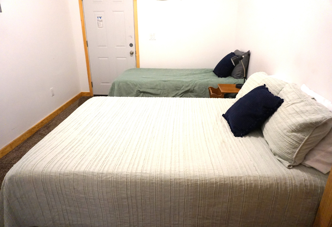 Another view of bedroom 3: queen bed and twin bed. 