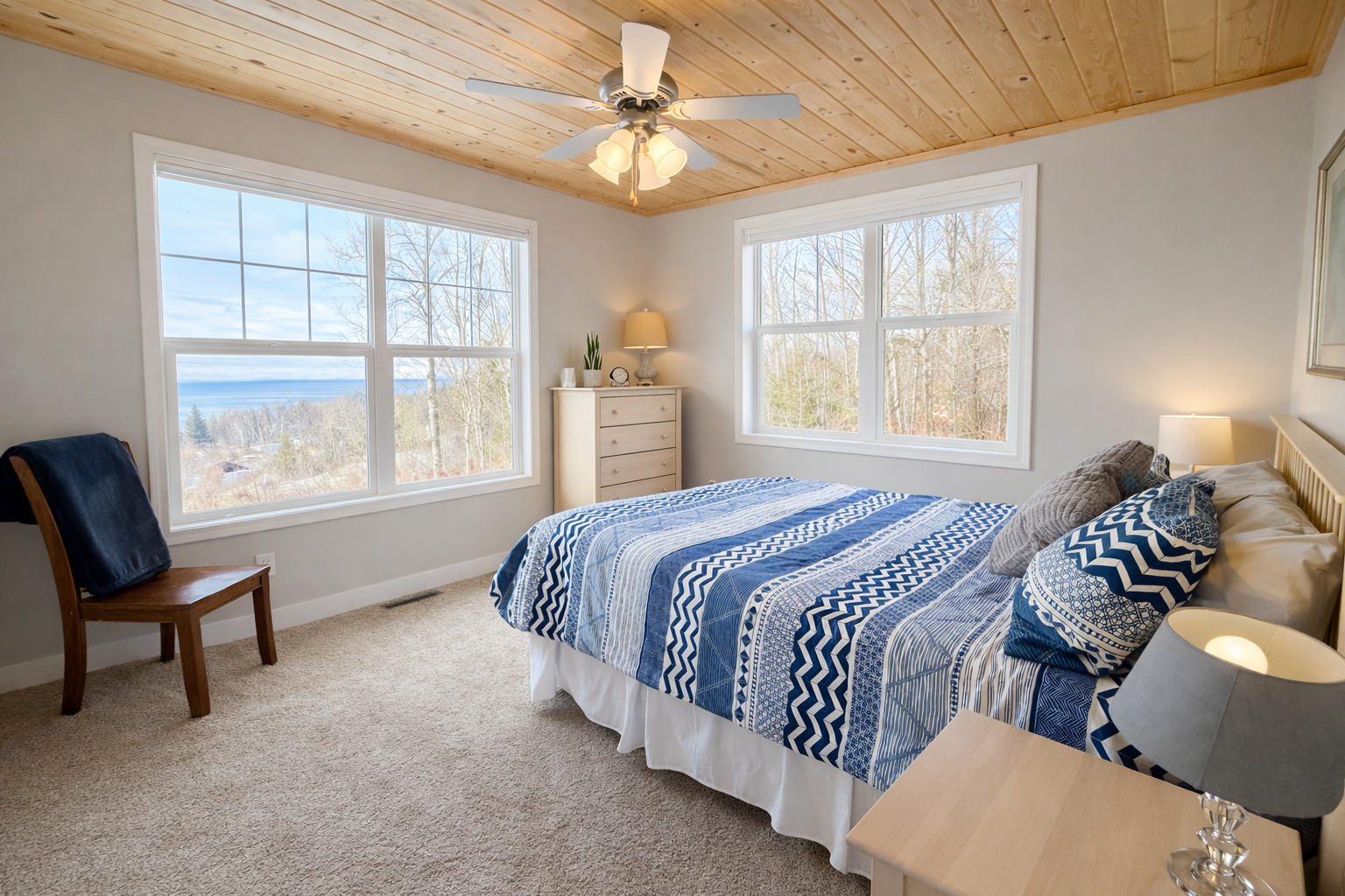 The upstairs primary bedroom is bright, open, and inviting, with a peaceful view of Lake Superior that instantly sets the tone for rest and relaxation. Cozy, thoughtfully designed, it’s a comfortable retreat where you can wake up to lake views and unwind. 