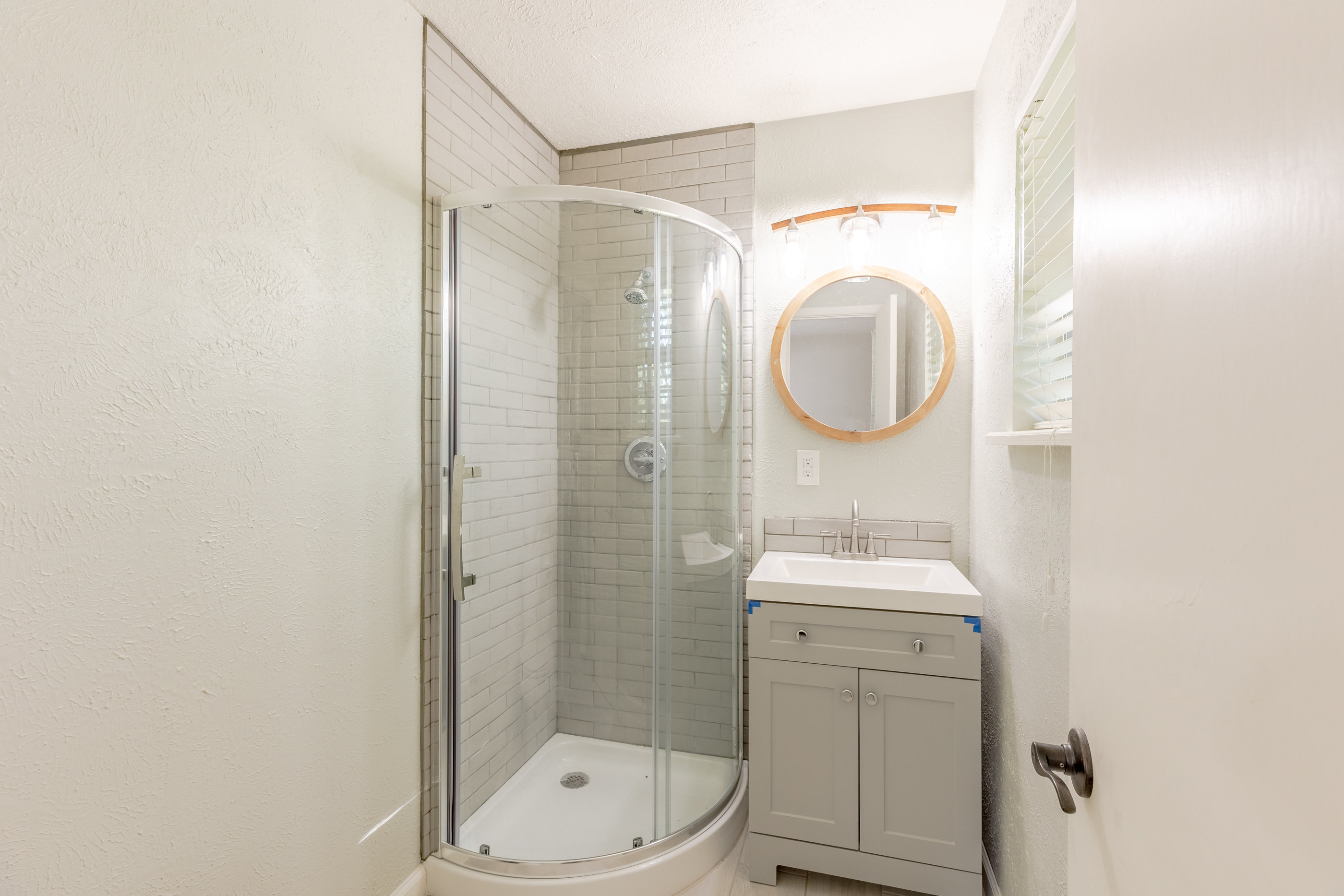 Quaint master bath with stand-in shower.