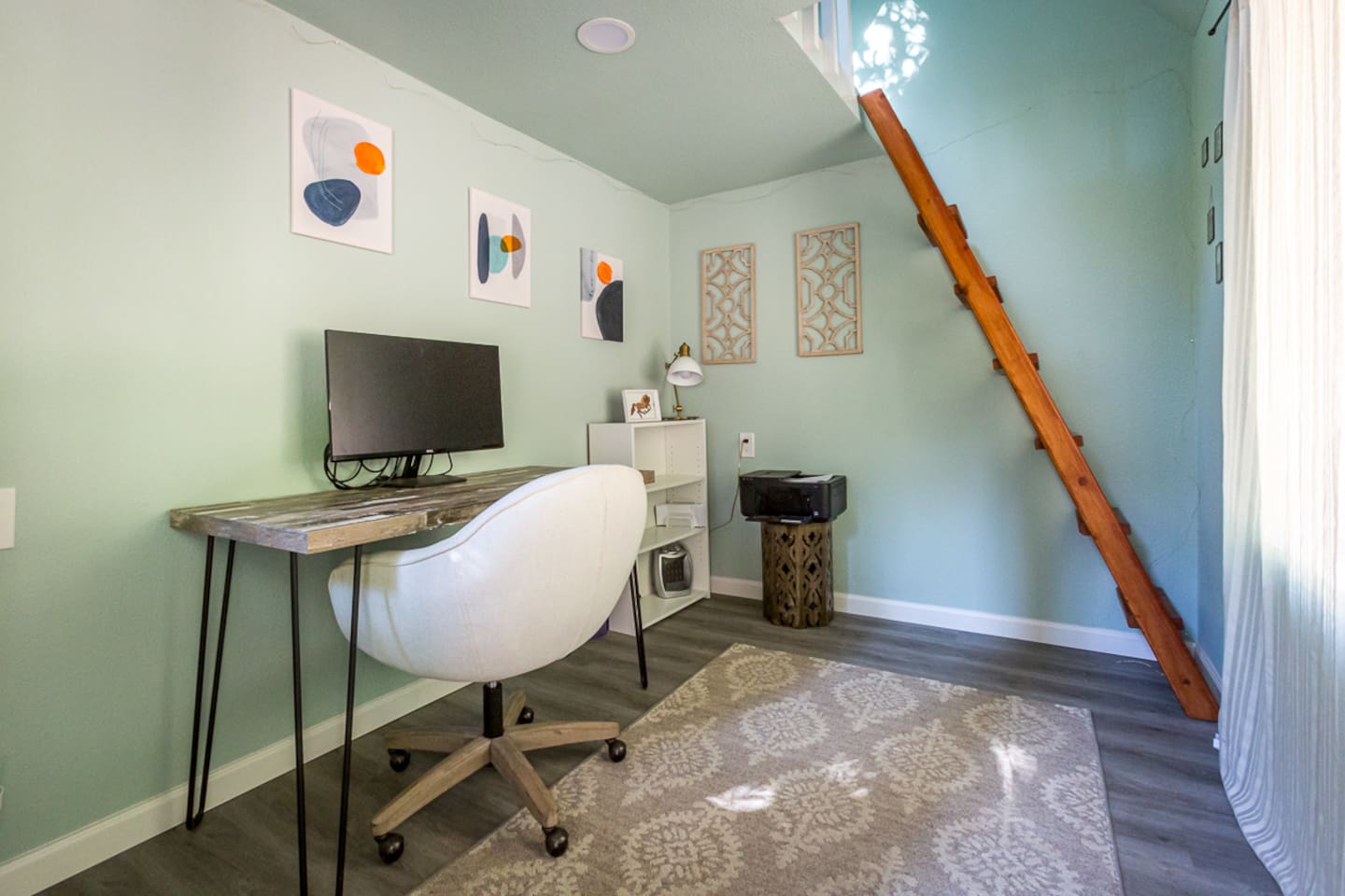 - Dedicated workspace with desk, chair, and monitor for remote work ease  
- Soft green walls and natural light make this office bright and inviting  
- Unique loft ladder adds character and connects to an upper level nook  
