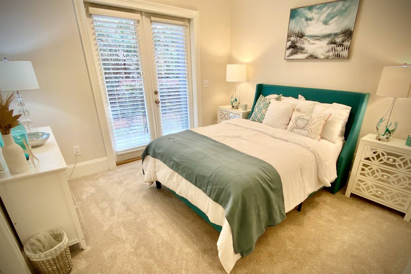 First Floor Bedroom with Queen bed and patio access.