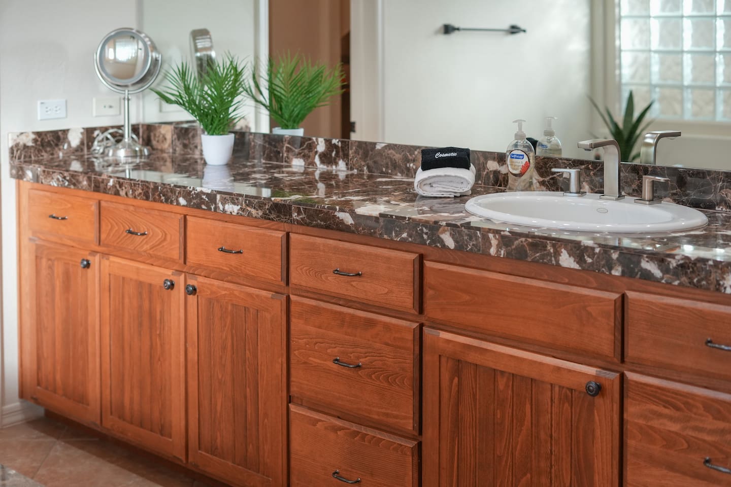 Double vanity with granite countertops and ample storage space.