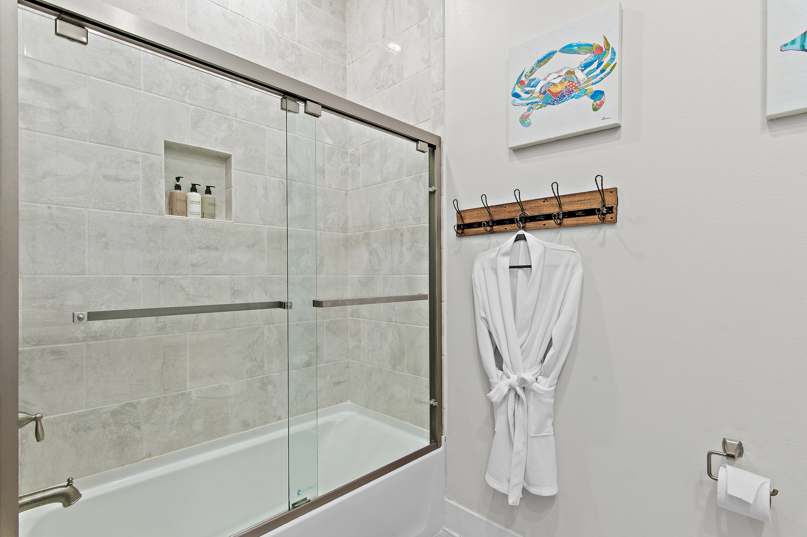 Modern, full-featured guest bathroom featuring a spacious shower and ample vanity space, conveniently located near the guest rooms for easy access and privacy.