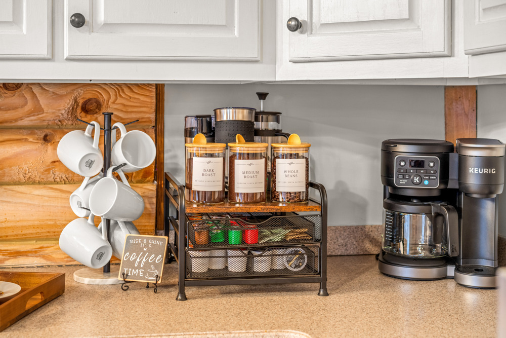 Coffee station stocked and ready—complete with mugs, a coffee maker, and essentials to help you start the day with ease.