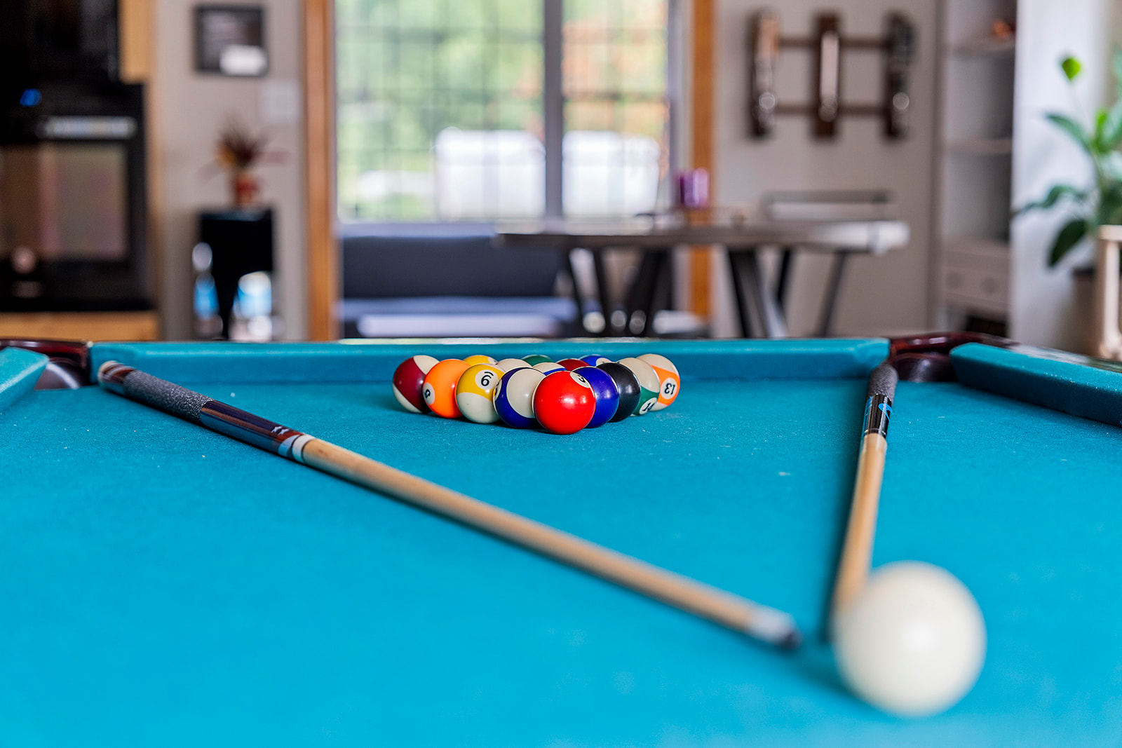 Living Room: Challenge friends to a fun-filled pool match in this vibrant space!