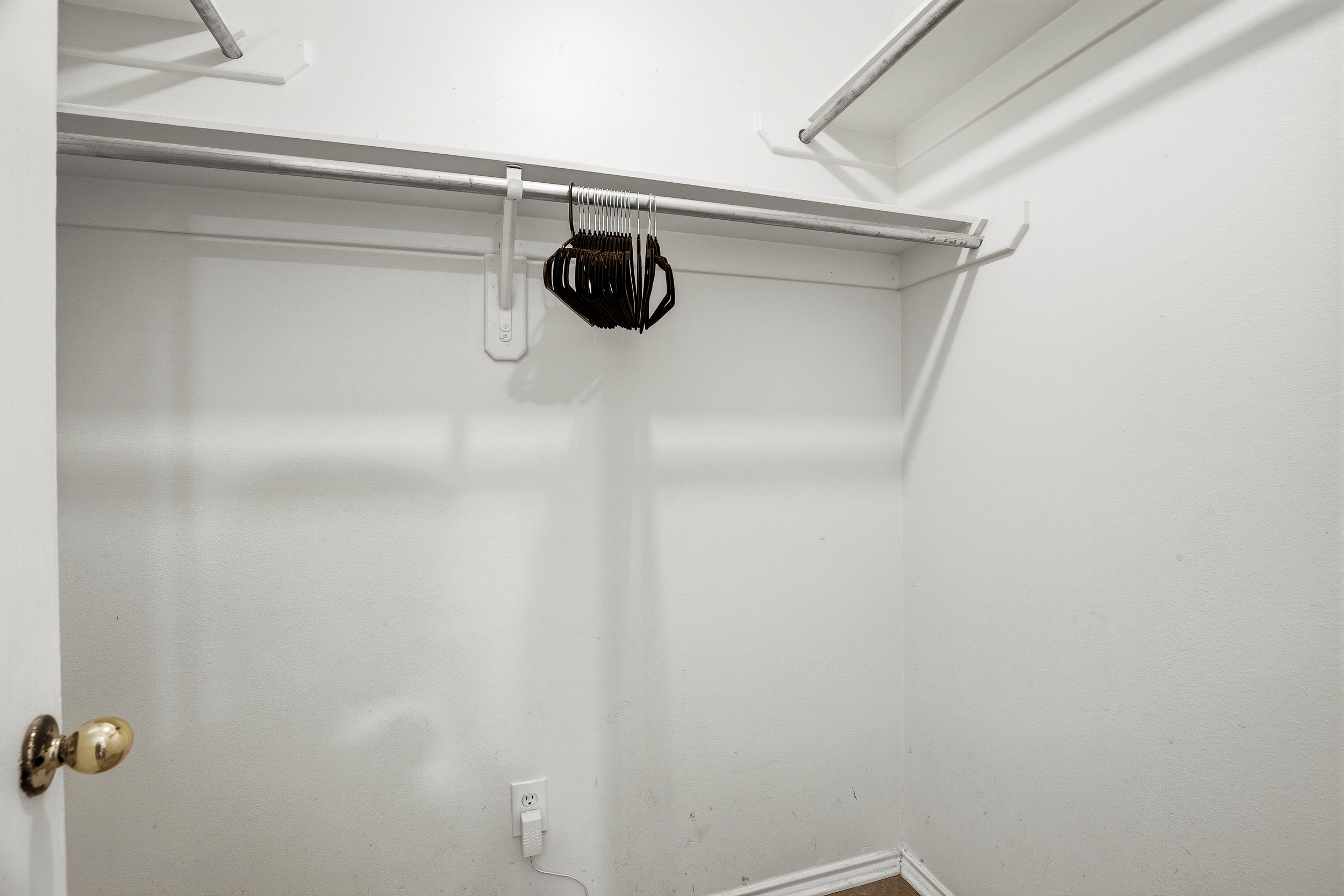 Spacious walk-in closet in the primary bedroom with full hanging rod, upper shelving, and hangers provided. Plenty of room to unpack and settle in for longer stays.