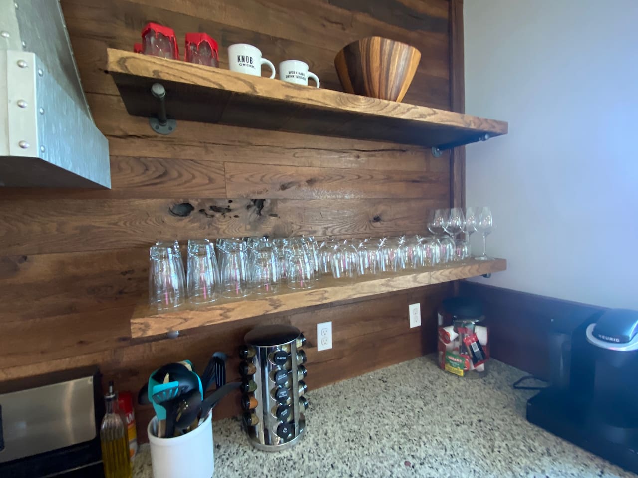 Drinking glasses and wine glasses for entertaining along with spices and some utensils for cooking.