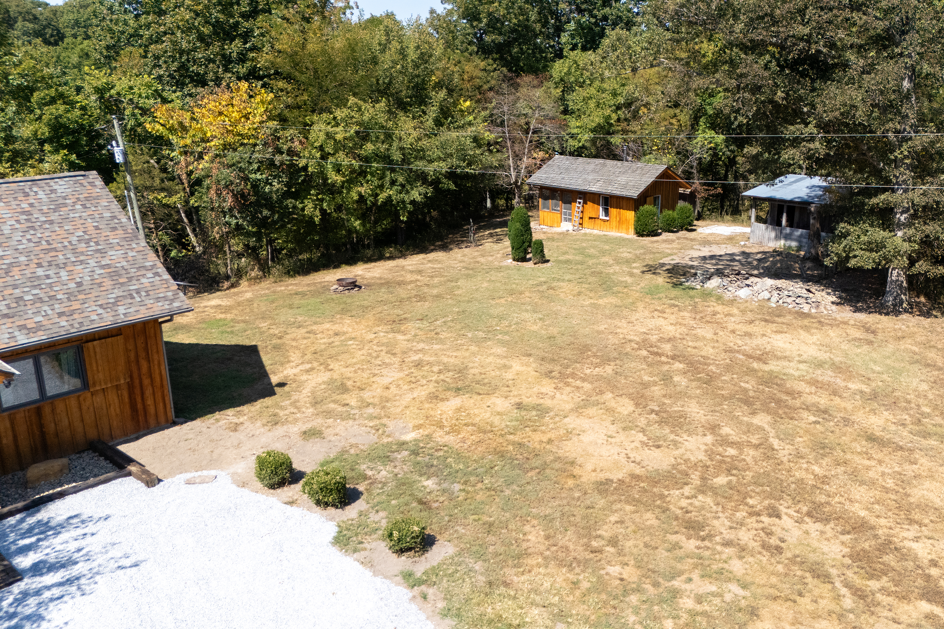 Aerial view of the side yard featuring the firepit, perfect for evenings under the stars.