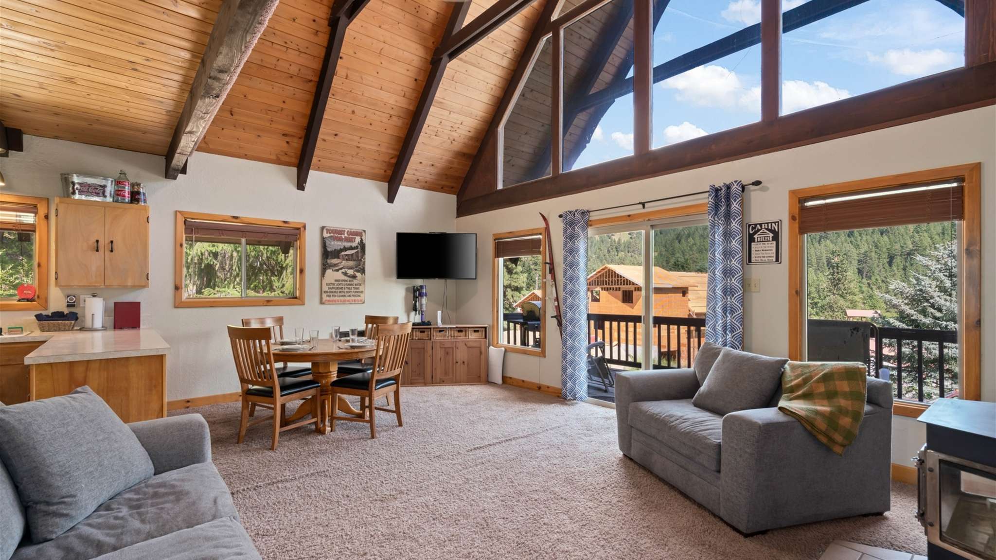 Large windows flood the cabin with natural light and forest views.