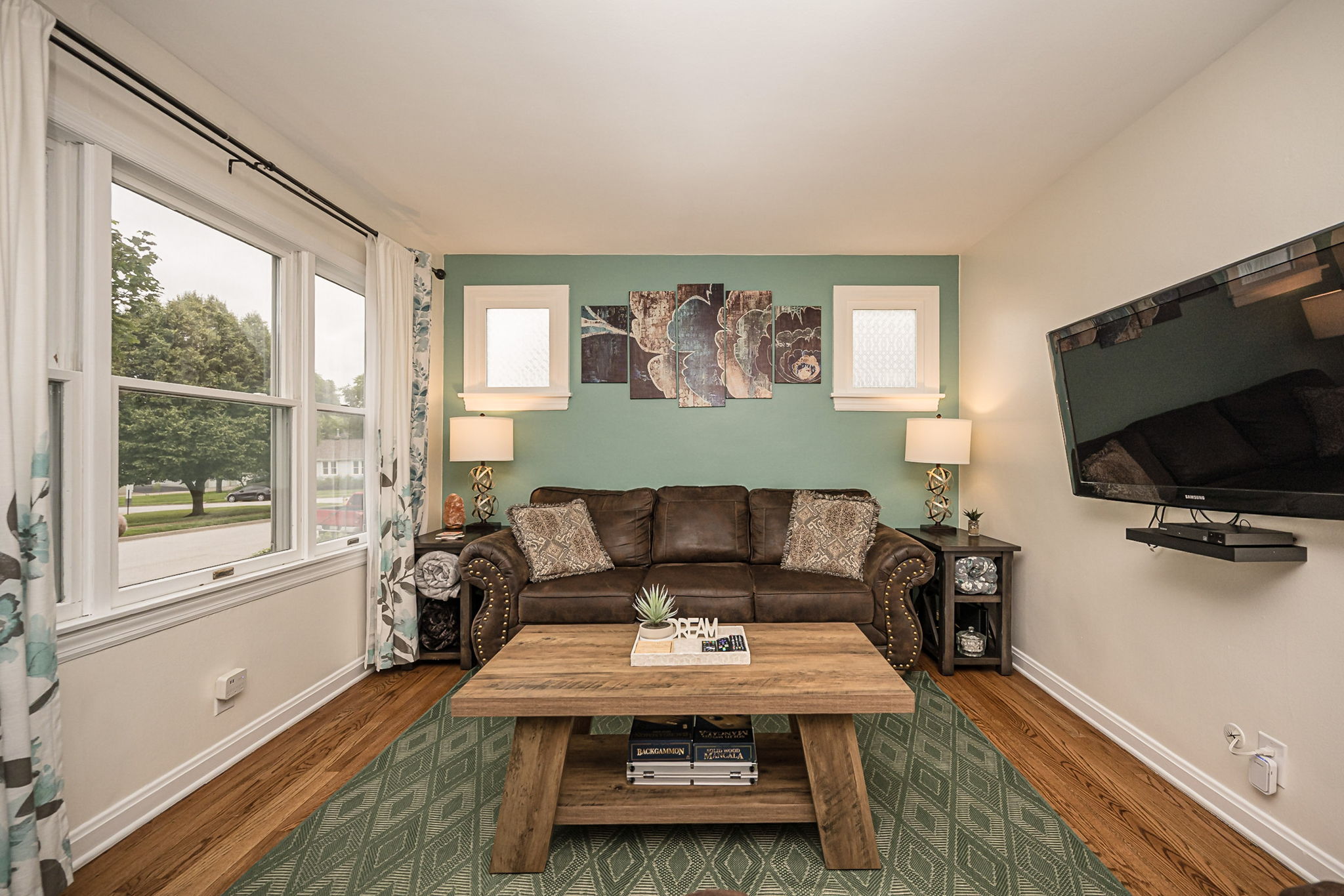 Large windows create a bright and inviting space to unwind.