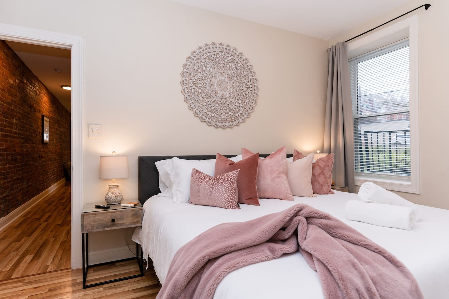 King-sized bedroom with a side window, offering plenty of natural light and comfort.
