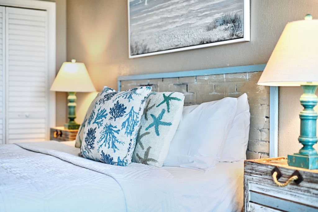 Rest up after a day in the sun in this plush, coastal-themed master suite.