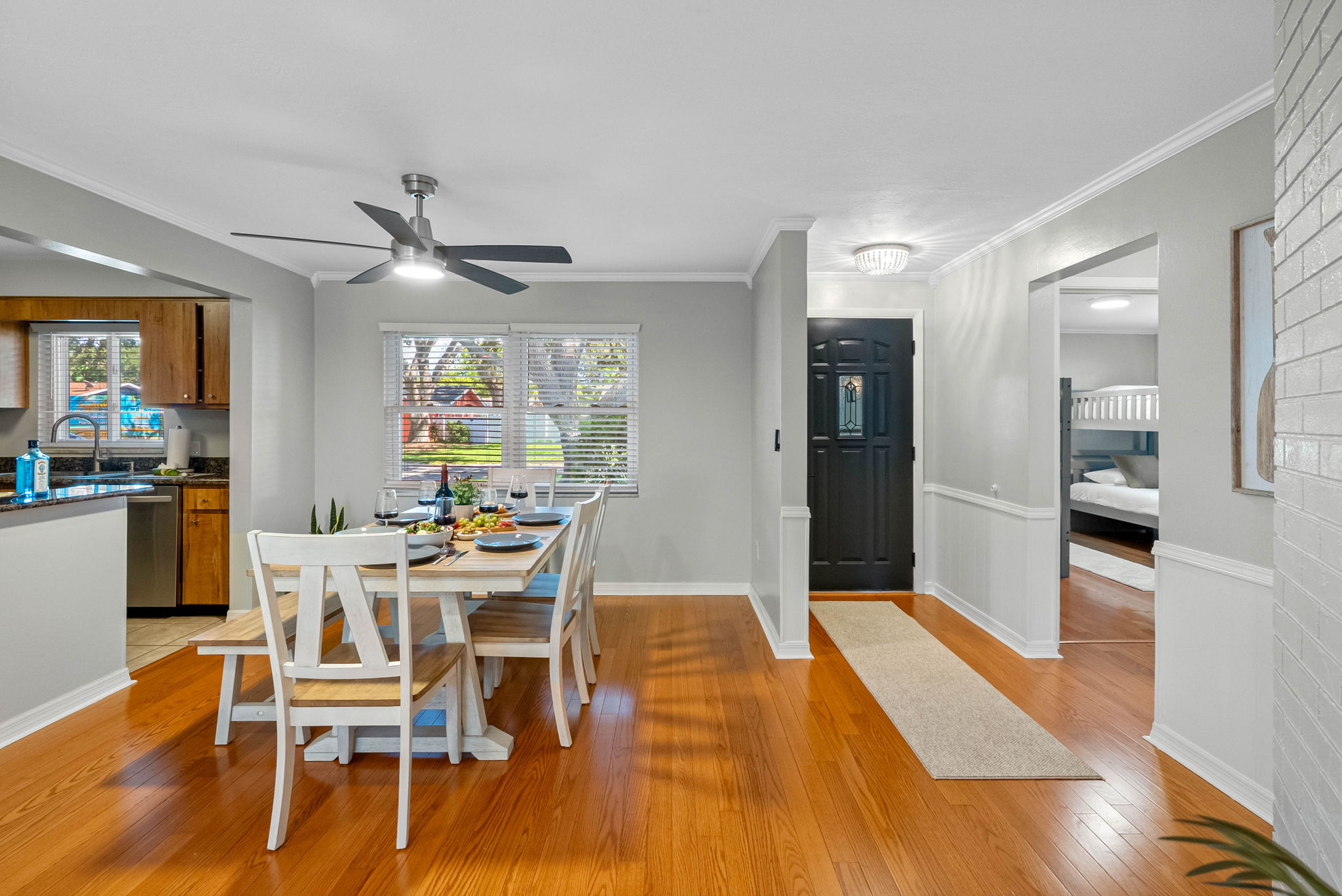 This warm, open-concept dining space is perfect for shared meals, laughter, and wine-filled evenings. Set with stylish tableware and a fresh charcuterie board, it’s ready for your next memorable moment.