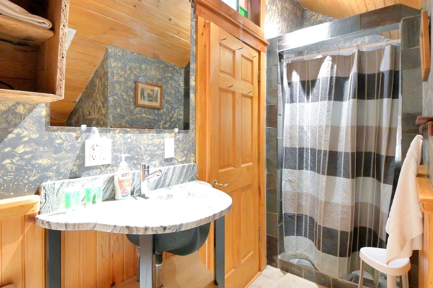 This bathroom is on the second floor of the house stocked with a stand up shower and a full washer/dryer combo! 