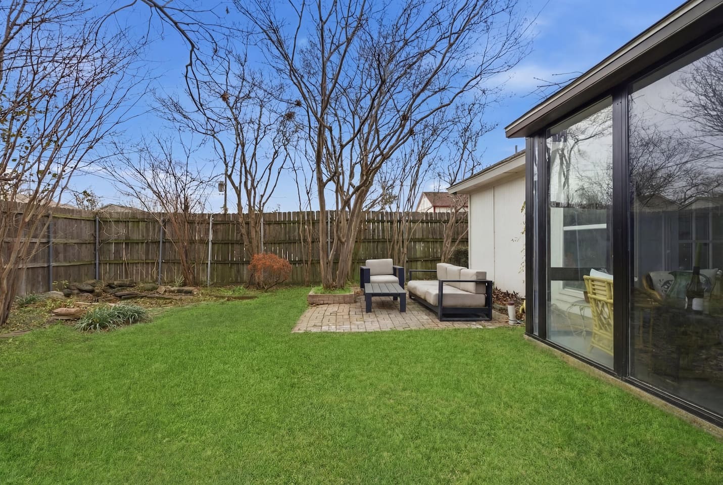 Private fenced yard with patio seating and peaceful surroundings for morning coffee or evening downtime.