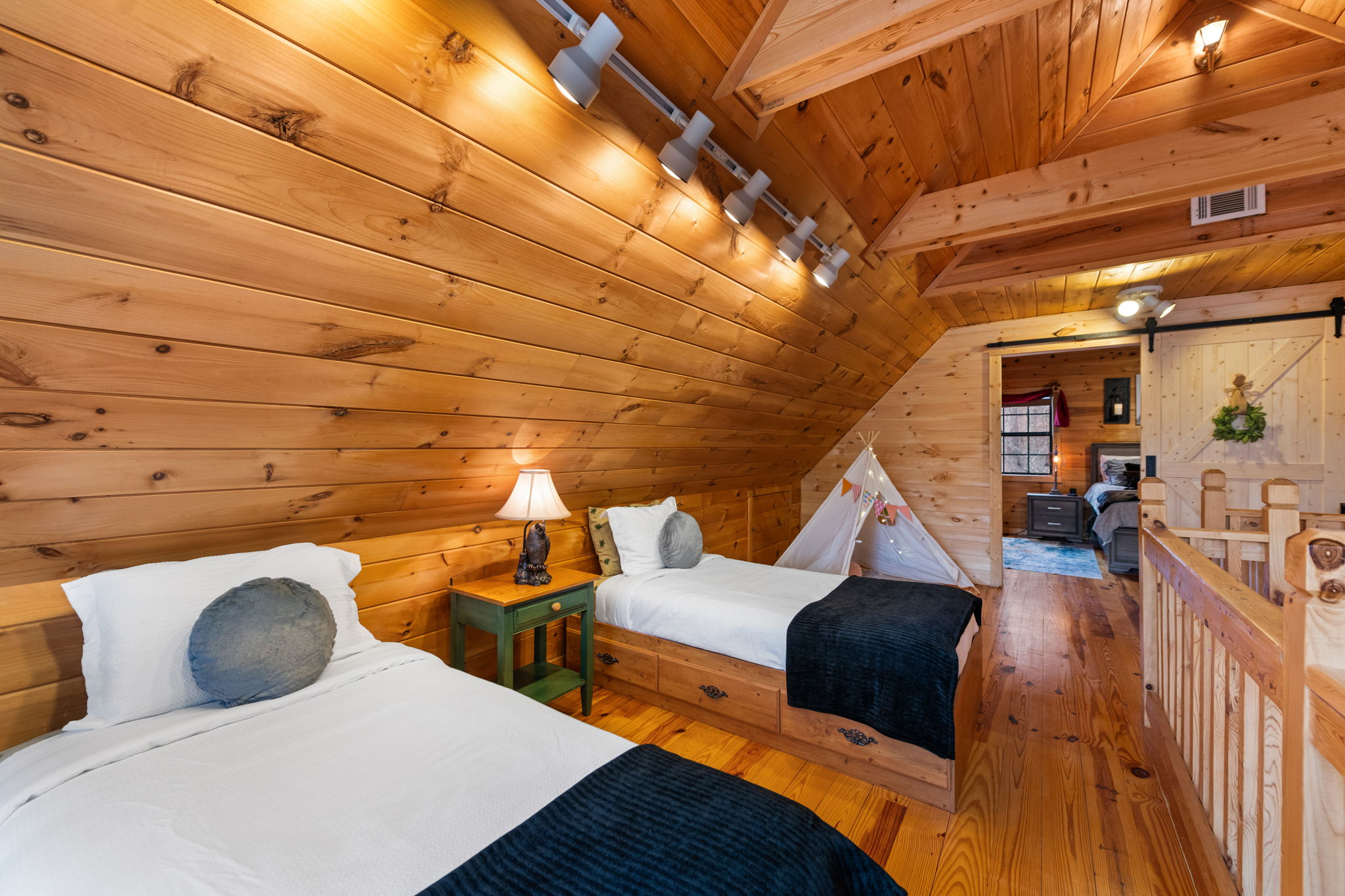 A cozy loft area located just before Bedroom 2 includes two twin-size beds, perfect for additional sleeping space.