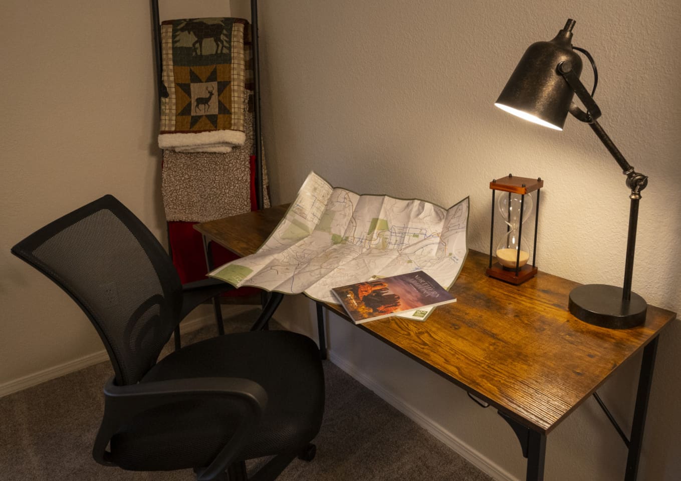 Bedroom workspace with desk, lamp, and chair for work trips or extended visits.