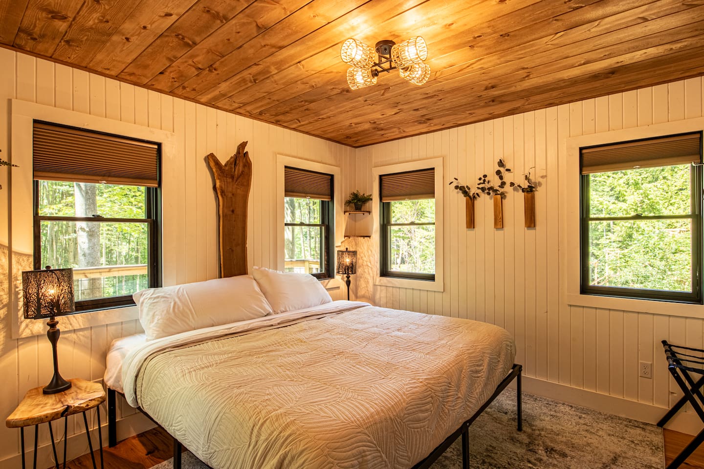 This bedroom hosts one king bed. The laundry facilities are in a closet located in this bedroom.