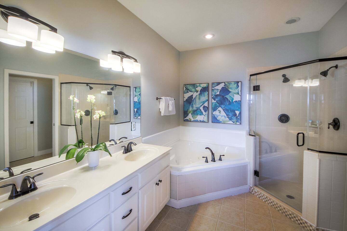 The master suite bathroom with double vanity, double shower heads and a jetted tub.