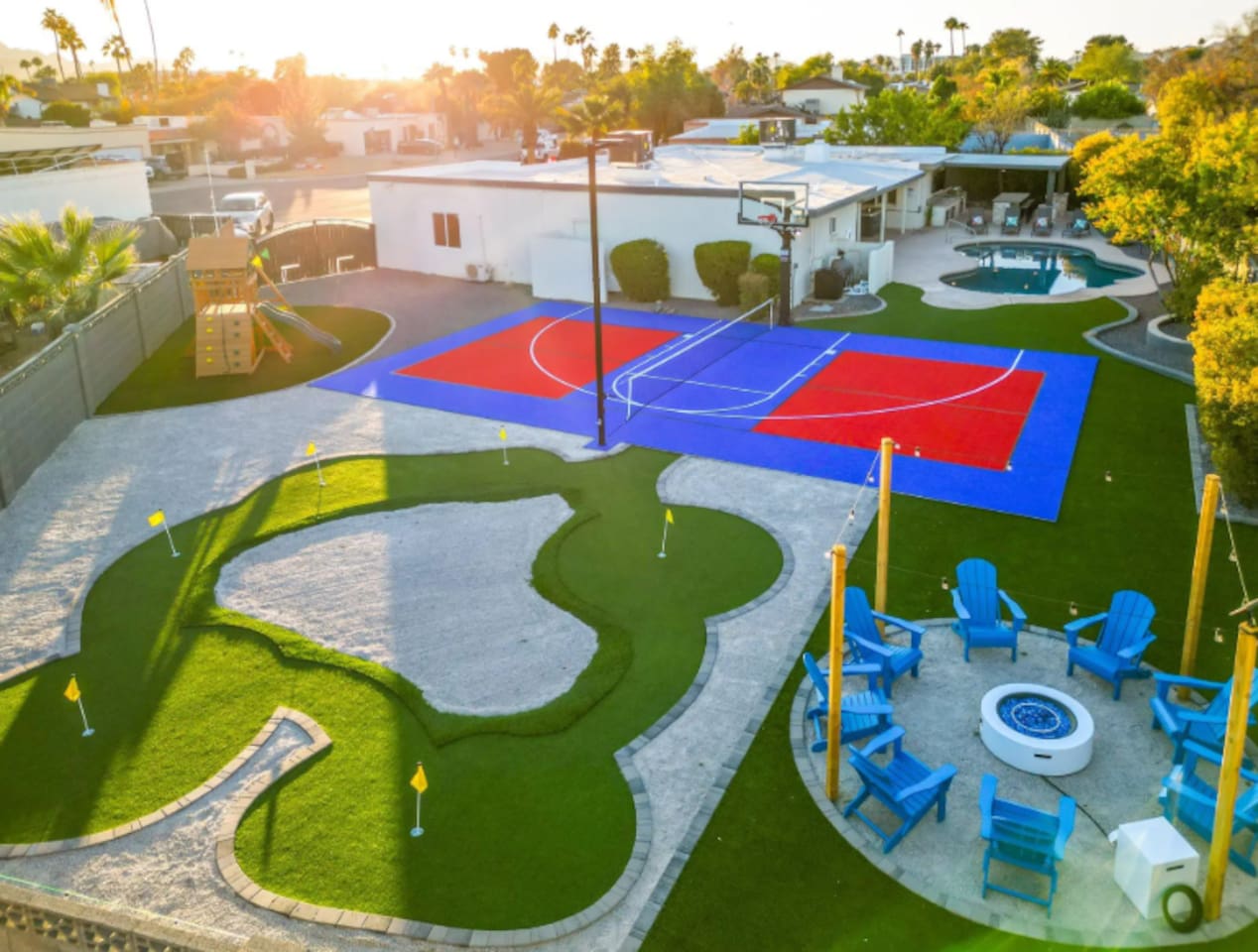 From above, the backyard reveals just how much this property has to offer: a full sport court, a putting course, and a fire pit lounge all within steps of each other.
