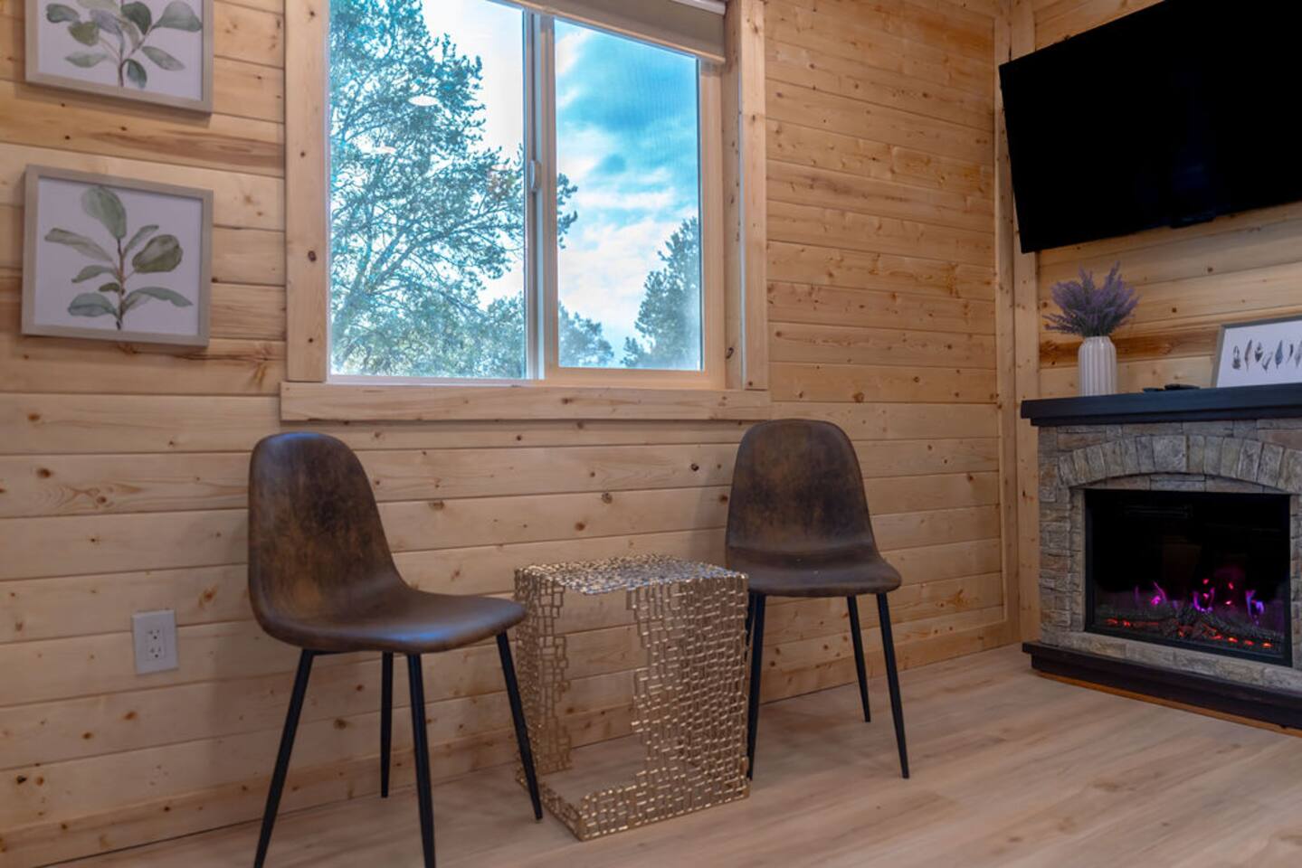 Sunlight pours into this cozy nook, showing off gorgeous views of juniper pines and the oh-so-inviting outdoor firepit area. Grab a seat, sip your coffee, and let nature work its magic—because mornings are better with a view like this!