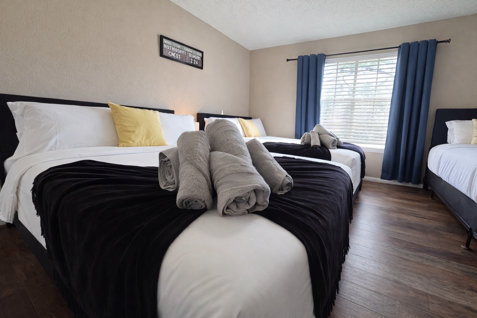 Spacious bedroom with 2 Queen beds and 1 Twin bed — great for large families and group accommodations. Comfortable mattresses and clean, modern design for a relaxing stay.