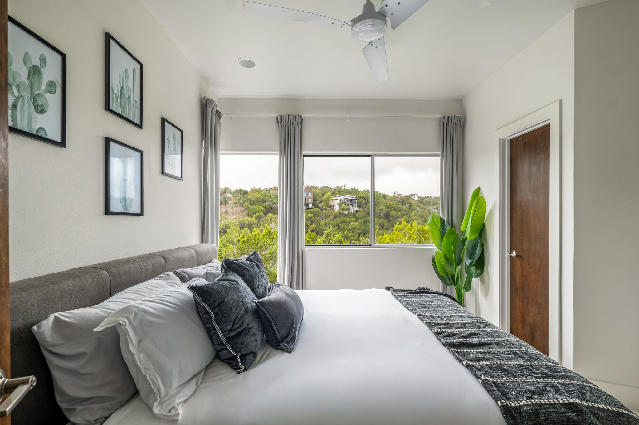 Bright and comfortable bedroom with large windows